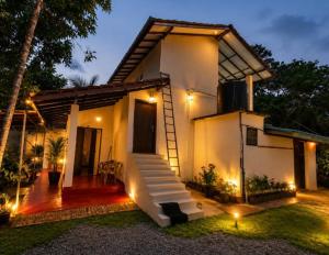a white house with a staircase in front of it at SunBeachHouse in Weligama