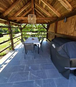 a patio with a table and chairs in a pavilion at Under The Castle in Dob