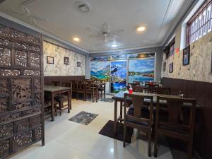 a dining room with wooden tables and chairs at City Star in Srinagar