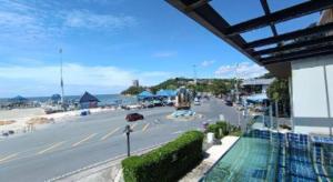 a view of a beach from a building with a street at The High One in Ban Laem Thaen