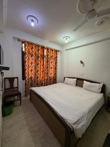 a bedroom with a large bed and a window at City Star in Srinagar +6 photos