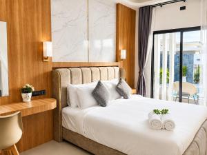 a bedroom with a bed with two towels on it at The Phuview Pool Villa Aonang in Ban Chong Phli +28 photos