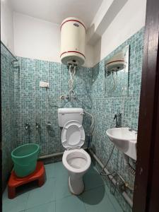 a bathroom with a toilet and a sink at City Star in Srinagar