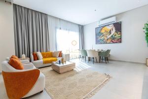 a living room with a couch and a table at Amber Hospitality - Arrawdha in Riyadh +25 photos