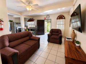 a living room with a couch and two chairs at EV's Place in San Ignacio