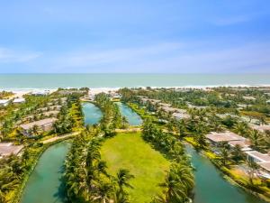 an aerial view of a resort with palm trees and the ocean at Meliá Ho Tram Beach Resort in Ho Tram +109 photos
