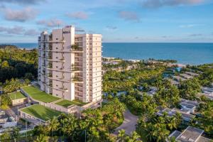 an aerial view of a tall building in front of the ocean at Meliá Ho Tram Beach Resort in Ho Tram