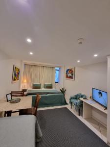 a bedroom with a bed and a living room at Vitória Marina Flat in Salvador