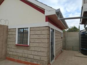 a side view of a house with a window at BlessRoyal Home in Kitengela 