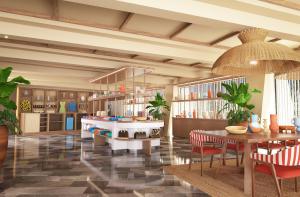a living room with a table and chairs and shelves at Zel Cozumel in Cozumel