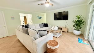 a living room with a couch and a tv at Relaxing place with pool in Cape Coral