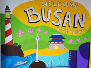 a box of welcome bim surprises with a welcome busan sign at Welcome Busan Guesthouse in Busan