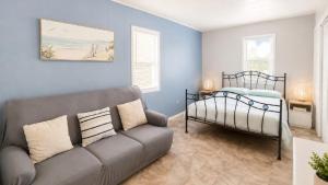 a living room with a couch and a bed at The Blue Groper in Minnie Water
