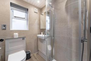 a bathroom with a shower and a toilet and a sink at 1 Bed in Hawkshead oc-lr154 in Hawkshead +15 photos