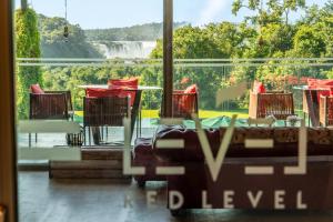 a room with a view of a waterfall through a window at Gran Meliá Iguazú in Puerto Iguazú