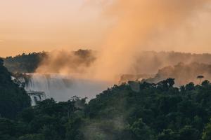 a view of a waterfall in the jungle with smoke at Gran Meliá Iguazú in Puerto Iguazú