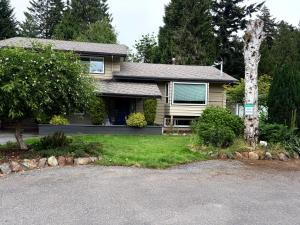 a house with a driveway in front of it at Charming Central Abbotsford Retreat, Cozy Suite in Abbotsford