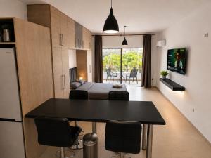 a room with a bed and a table and chairs at Maison Amalthea in Limassol