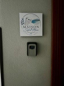 a sign hanging on a wall with a switch at Maison Sofia Mare in Silvi Marina