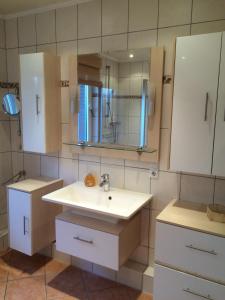 a bathroom with a sink and a mirror at Haus Nicole in Cuxhaven +100 photos