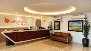 an office with a reception desk and a chair at Orange Hotel Kota Kemuning @ Shah Alam in Shah Alam