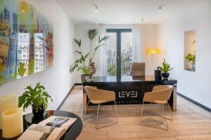 a living room with a black desk and chairs at Meliá Berlin in Berlin