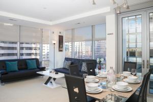 a living room with a table and a couch at Arlington Fully Furnished Apartments in Crystal City in Arlington
