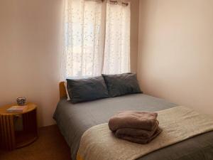 a bedroom with a bed with a pillow and a window at Villa LaNoah in Kalbarri
