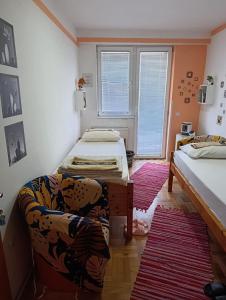 a living room with two beds and a couch at Agape in Niš