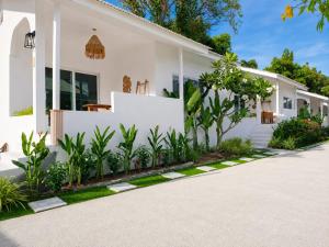a white house with plants in front of it at Lavoe Villas Samui in Nathon Bay