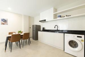 a kitchen with a sink and a washing machine at Walk Street Hotel & Apartment in Phnom Penh