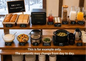 a counter with a microwave and various food items at Komorebi Myoko Lodge in Myoko