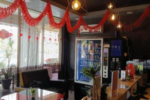 a store with a soda machine and red decorations at Golden Night Hotel Sunway in Petaling Jaya