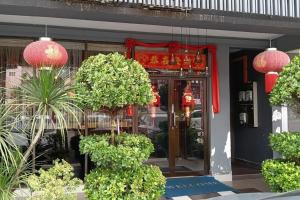 a store front with plants in front of a building at Golden Night Hotel Sunway in Petaling Jaya