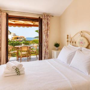 a bedroom with a bed and a view of the ocean at Angela Studios in Syvota