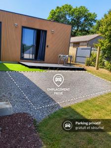 a building with a sign in front of a house at Le Cocon de Brocéliande - Studio cosy et indépendant in Saint-Thurial +2 photos