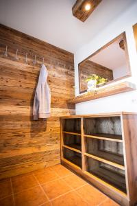 a bathroom with wooden walls and a mirror at Grafenberg Chalet in Wagrain