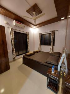 a bedroom with a large bed in a room at Vighnaharta Homestay in Ganpatipule +9 photos