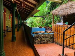 a porch with a table with bread on it at Terico resort in Belihuloya