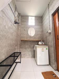 a small kitchen with a refrigerator and a staircase at Suchanaree@Laemngop in Trat +71 photos