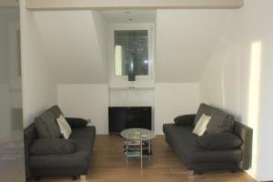 a living room with two couches and a table at New appartment Design Montreux in Montreux