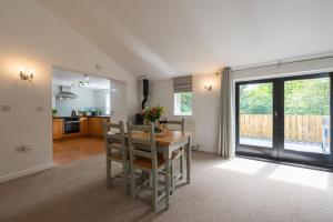 a kitchen and dining room with a table and chairs at Warner - Treworgie Barton Cottages in Bude