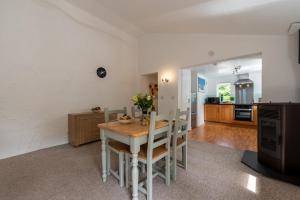 a kitchen and dining room with a table and chairs at Warner - Treworgie Barton Cottages in Bude +48 photos
