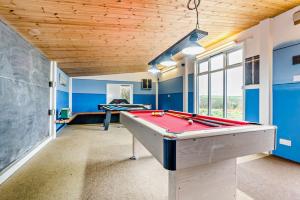 a pool table in a room with blue walls at Warner - Treworgie Barton Cottages in Bude