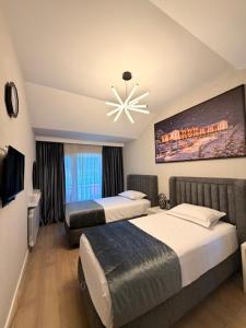 a hotel room with two beds and a chandelier at Chanko's Cottages in Tsemi +33 photos