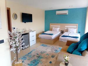 a hotel room with two beds and a couch at MIRA Holiday Home in Cairo