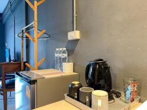 a kitchen with a counter top with a refrigerator at Warehouse18 Pool Cafe Resort in Don Sak