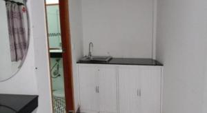 a small white bathroom with a sink and a mirror at Unique Hotel in Phnom Penh +84 photos