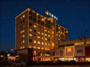 a tall building with lights on top of it at night at Cheermay Hotels in Dongguan