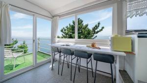 a kitchen with a counter with a view of the ocean at Namhae baramundeok Pension in Namhae